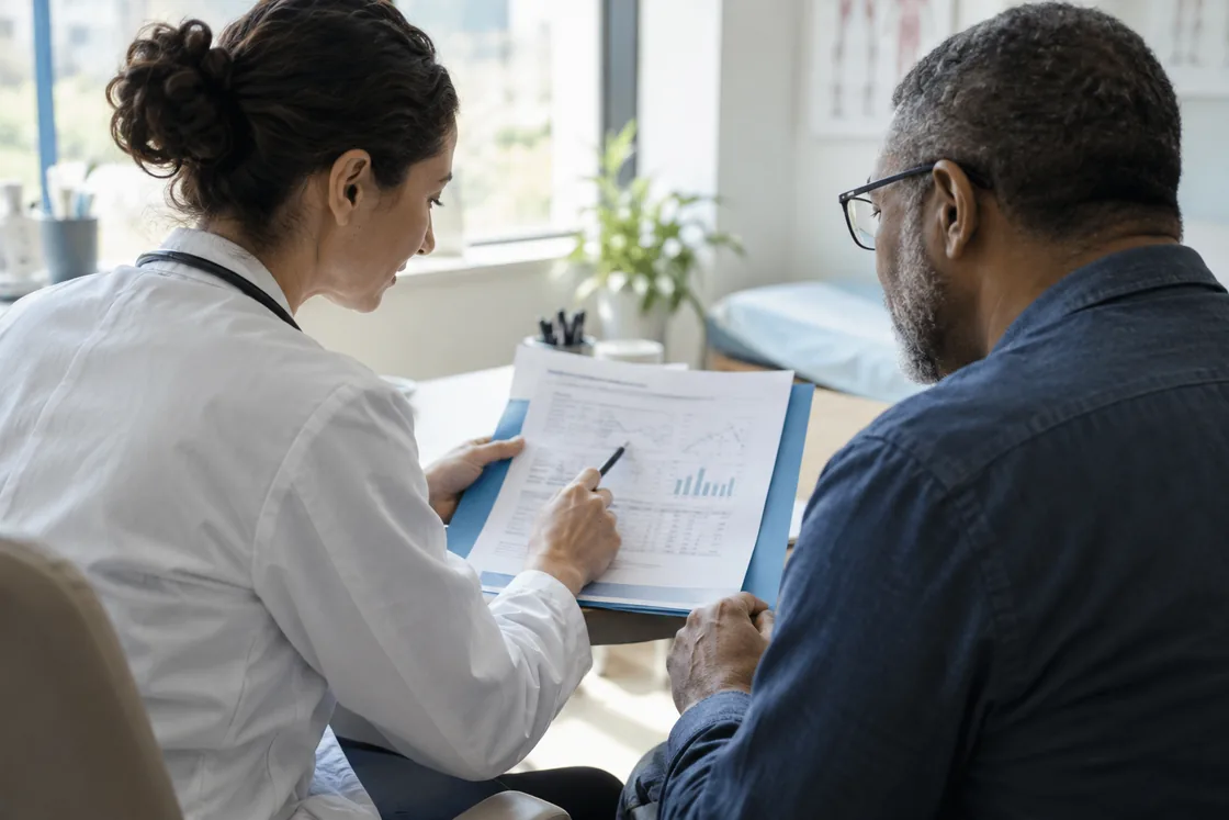 A clinician and patient reviewing a report together.